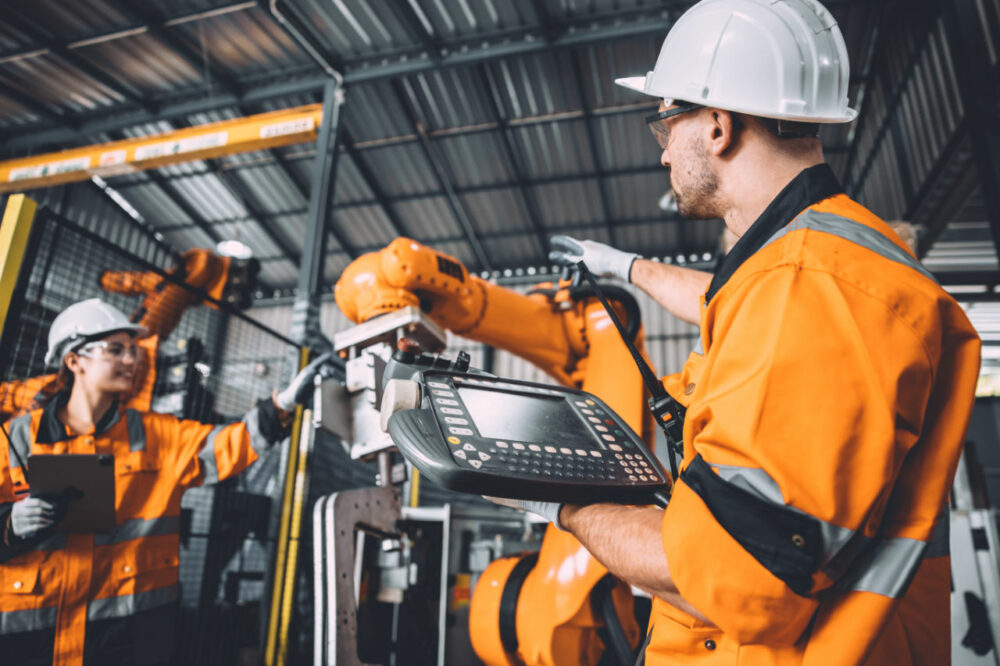 Engineer team service robot welding working in automation factor